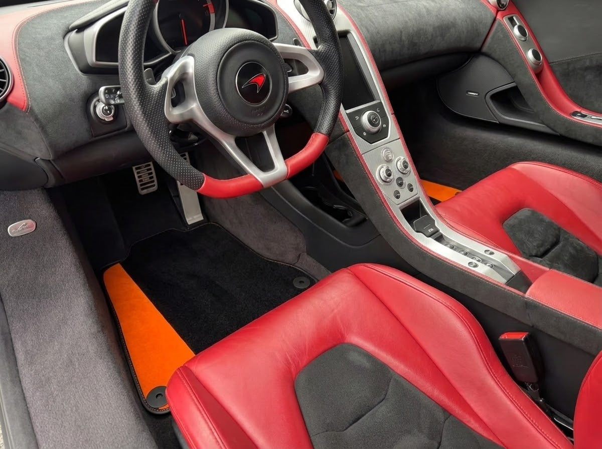 Svarte bilmatter for McLaren MP4-12C (2011–2014) med oransje Alcantara-skinn